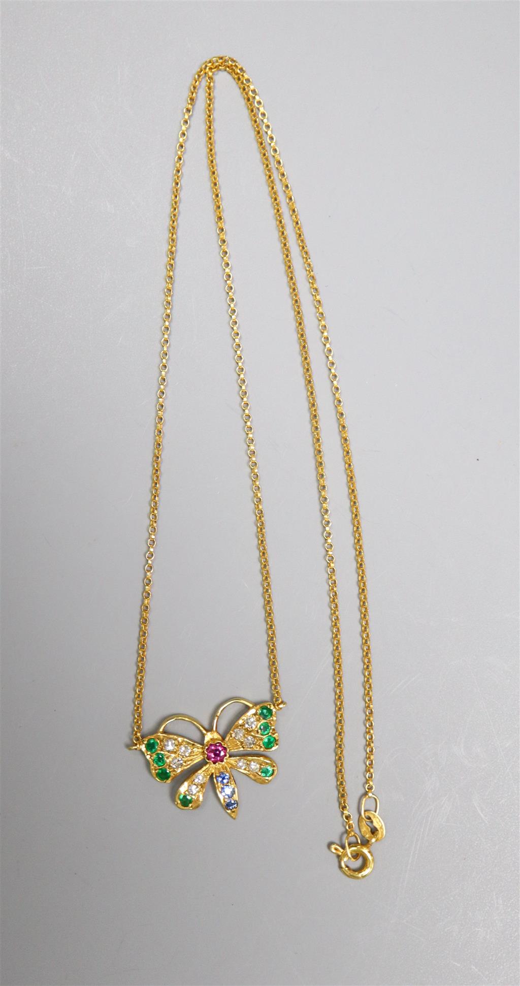 A modern 9ct gold, ruby, emerald, sapphire and diamond set butterfly pendant necklace, 45cm, gross 2.8 grams.